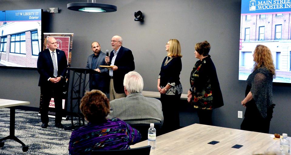 Wayne County Commissioners Ron Amstutz, Sue Smail and Becky Foster accept the Main Street design award for exterior work at the renovated county offices and courthouse 117 West Liberty St.