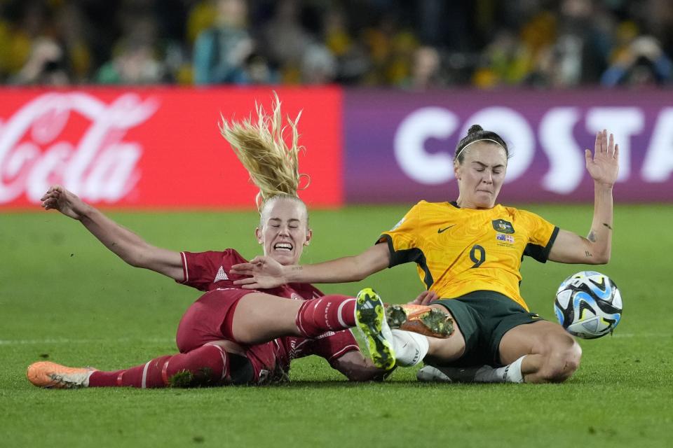 Denmark's Amalie Vangsgaard, left, and Australia's Caitlin Foord fight for the ball during the Women's World Cup round of 16 soccer match between Australia and Denmark at Stadium Australia in Sydney, Australia, Monday, Aug. 7, 2023. (AP Photo/Mark Baker)