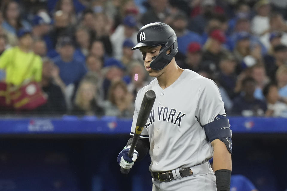 New York Yankees' Aaron Judge spits out his gum after striking out during sixth-inning baseball game action against the Toronto Blue Jays in Toronto, Monday, Sept. 26, 2022. (Nathan Denette/The Canadian Press via AP)