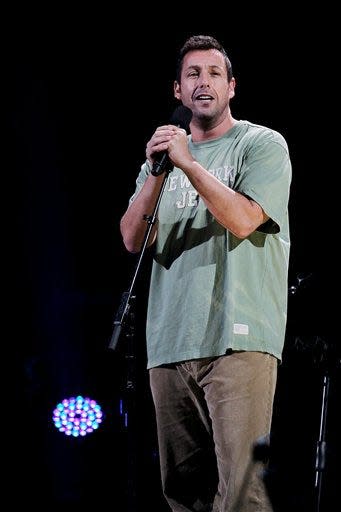 This image released by Starpix shows Adam Sandler performing at the 12-12-12 The Concert for Sandy Relief.