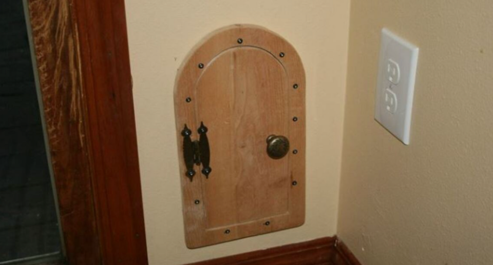 A timber tiny door with a brass knob.