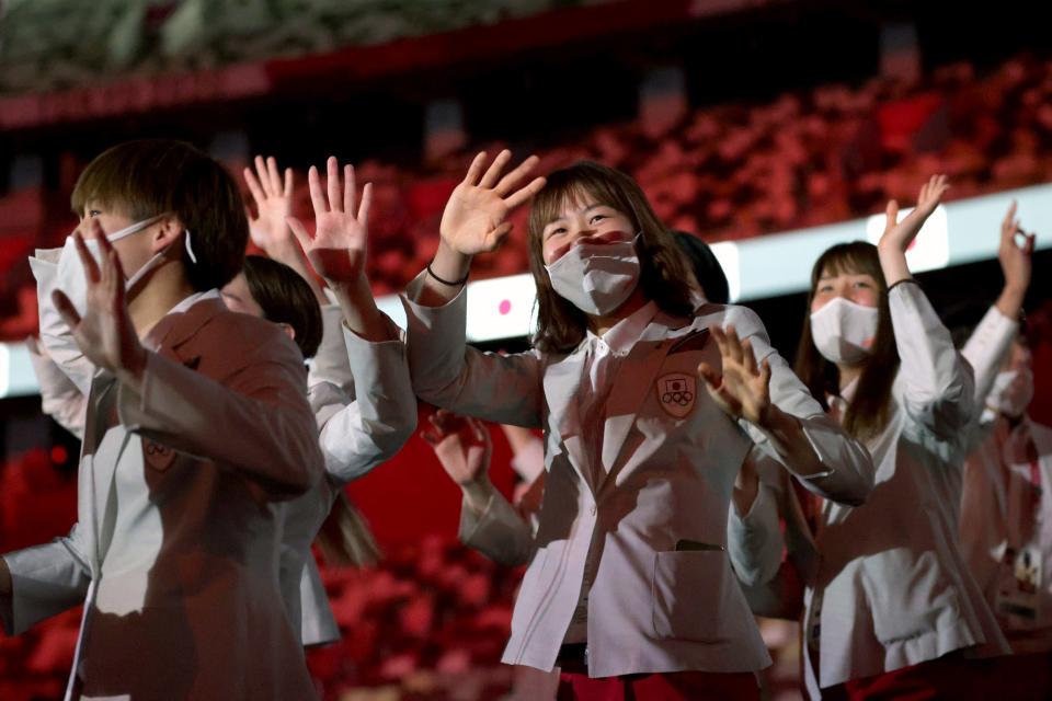 Athletes from Team Japan enter Tokyo's Olympic Stadium during the opening ceremony.