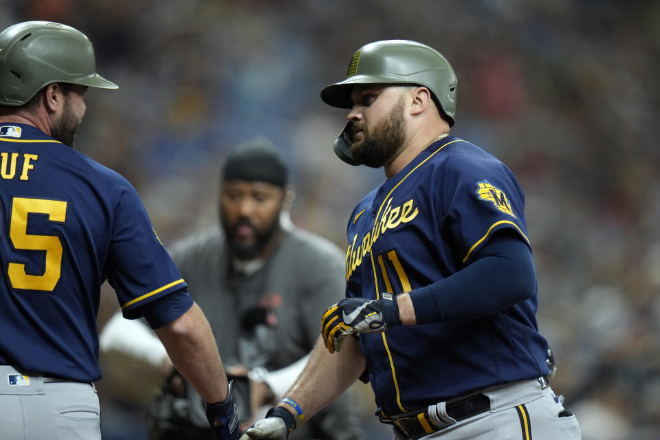 Milwaukee Brewers' Rowdy Tellez (11) celebrates his two-run home run off Tampa Bay Rays' Cooper Criswell with Darin Ruf during the fourth inning of a baseball game Sunday, May 21, 2023, in St. Petersburg, Fla. (AP Photo/Chris O'Meara)