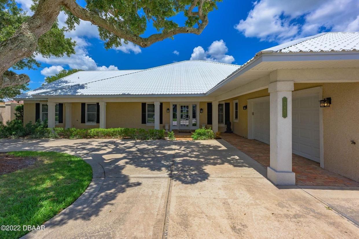 A beautiful oak sits in the middle of the circular driveway, offering a shady welcome to this multi-million-dollar estate on the Intracoastal Waterway in Ormond Beach.