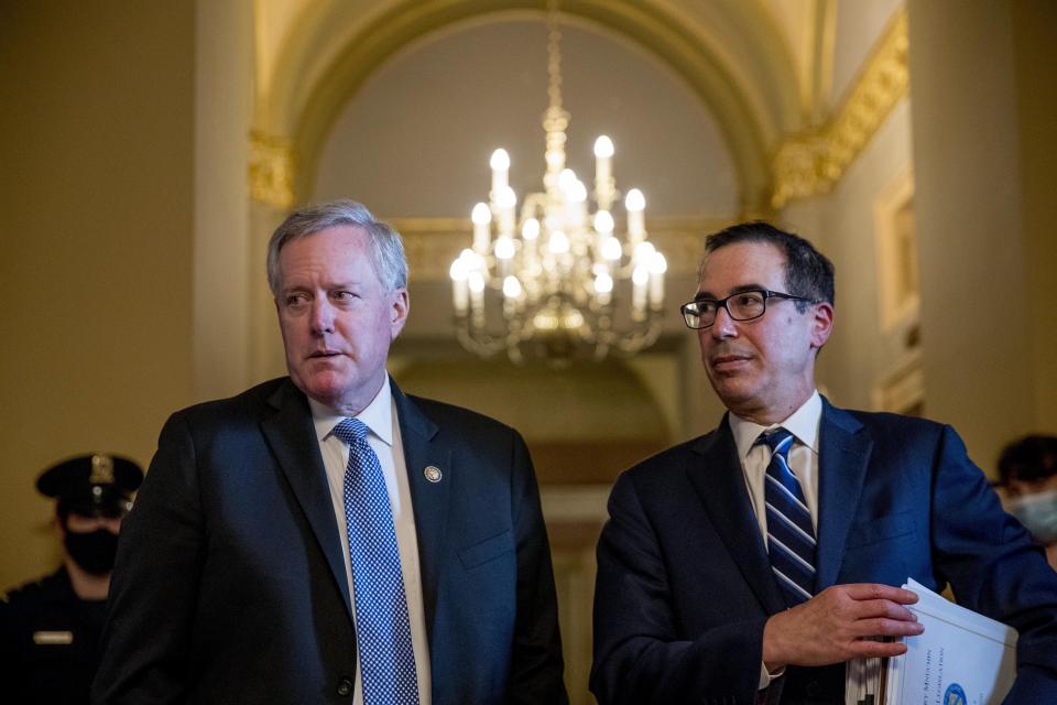 White House chief of staff Mark Meadows, left, accompanied by Treasury Secretary Steven Mnuchin, right, speaks to members of the media following a meeting with Senate Majority Leader Mitch McConnell of Ky. as negotiations continue with Senate Minority Leader Sen. Chuck Schumer of N.Y. and House Speaker Nancy Pelosi of Calif. on a coronavirus relief package on Capitol Hill in Washington, Tuesday, Aug. 4, 2020. (AP Photo/Andrew Harnik)