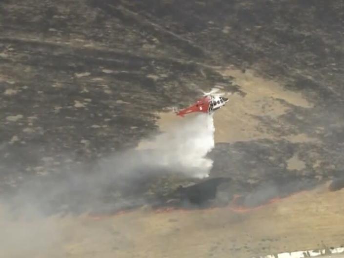 A brush fire that broke out Thursday afternoon was threatening homes in Sylmar, officials said. More than 100 firefighters were battling the blaze.