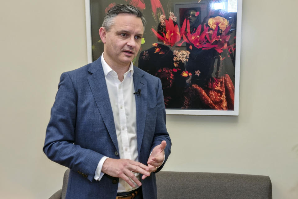 New Zealand's Climate Change Minister James Shaw speaks during an interview with The Associated Press in his office in Wellington, New Zealand, Wednesday, Oct. 13, 2021. The coronavirus pandemic has shown that humans are very good at responding to an immediate crisis, says Shaw. But when it comes to dealing with a slower-moving threat like climate change, he says, we're "terribly bad." (AP Photo/Sam James)