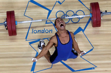 Micronesia's Manuel Minginfel drops weights on the men's 62kg Group B weightlifting competition at the London 2012 Olympic Games in Britain July 30, 2012. REUTERS/Dominic Ebenbichler