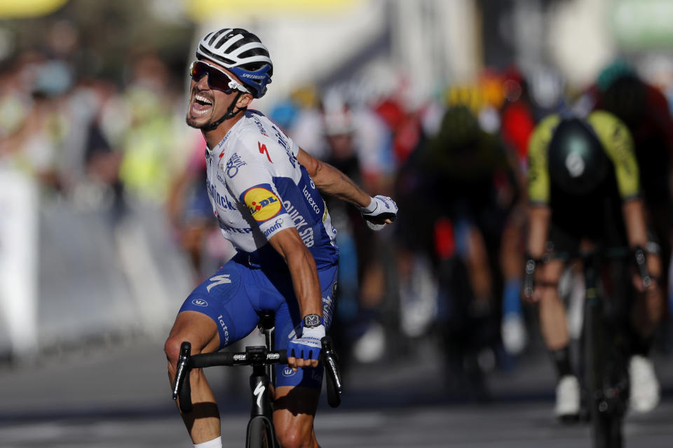 France's Julian Alaphilippe, celebrates as he crosses the finish line to win the second stage of the Tour de France cycling race over 186 kilometers (115,6 miles) with start and finish in Nice, southern France, Sunday, Aug. 30, 2020. Switzerland's Marc Hirschi finished second. (Stephane Mahe/Pool photo via AP)