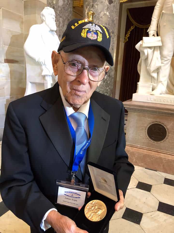 James Sciple holding his duplicate medal.