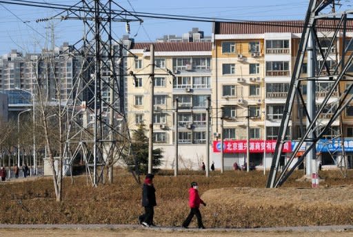 This file photo shows apartment blocks on the outskirts of Beijing. Growth in China, the world's second-largest economy, has slowed for six consecutive quarters and expanded 7.6 percent in the three months ended June 30, its worst performance in three years