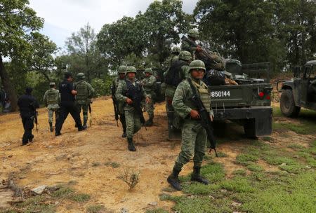 Soldiers meet with members of the Citizen Police of Leonardo Bravo to plan for joint patrols in the area, in Leonardo Bravo, Mexico June 21, 2018. REUTERS/Javier Verdin