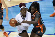 Louisville's Olivia Cochran, left, handles the ball in the post as Syracuse's Maeva Djaldi-Tabdi, right, defends during the first half of an NCAA college basketball game in the semifinals of Atlantic Coast Conference tournament in Greensboro, N.C., Saturday, March 6, 2021. (AP Photo/Ben McKeown)