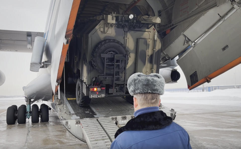 In this photo taken from video released by the Russian Defense Ministry Press Service, Russian peacekeepers board a vehicle on a Russian military plane at an airfield outside Moscow, in Russia, to fly to Kazakhstan, Thursday, Jan. 6, 2022. A Russia-led military alliance, the Collective Security Treaty Organization, said early Thursday that it would send peacekeeper troops to Kazakhstan at the request of President Kassym-Jomart Tokayev. (Russian Defense Ministry Press Service via AP)