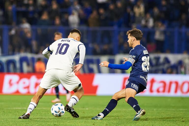 Rubén Botta, de Talleres, intenta desequilibrar ante la marca de Agustín Bouzat, doble 5 de Vélez