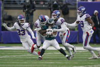 New York Giants defenders tackle Philadelphia Eagles' Boston Scott, center, during the first half of an NFL football game, Sunday, Nov. 28, 2021, in East Rutherford, N.J. (AP Photo/Corey Sipkin)