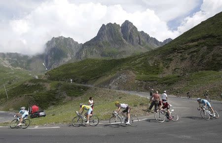 The pack of riders including race leader Astana team rider Vincenzo Nibali of Italy cycles during the 145.5km 18th stage of the Tour de France cycling race between Pau and Hautacam in the French Pyrennes mountains, July 24, 2014. REUTERS/Jacky Naegelen