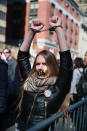 <p>A young woman wears handcuffs and has her mouth taped shut with the words “F*** TRUMP” inside police barricades at the “Not My President’s Day” rally at Central Park West in New York City on Feb. 20, 2017. (Gordon Donovan/Yahoo News) </p>