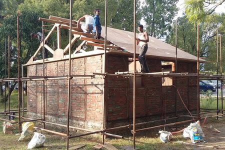 Construction workers make the final touches to a prototype house of the Nepal House Project designed by Japanese architect Shigeru Ban in Kathmandu October 15, 2015. REUTERS/Shigeru Ban Architects/Handout via Reuters