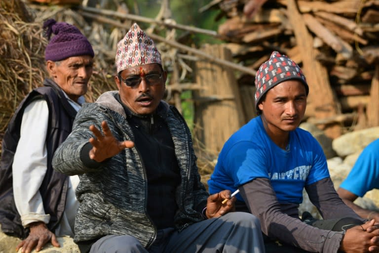 Nepalese shaman Keshar Giri (C) talks to AFP in Surkhet District, some 520 km west of Kathmandu