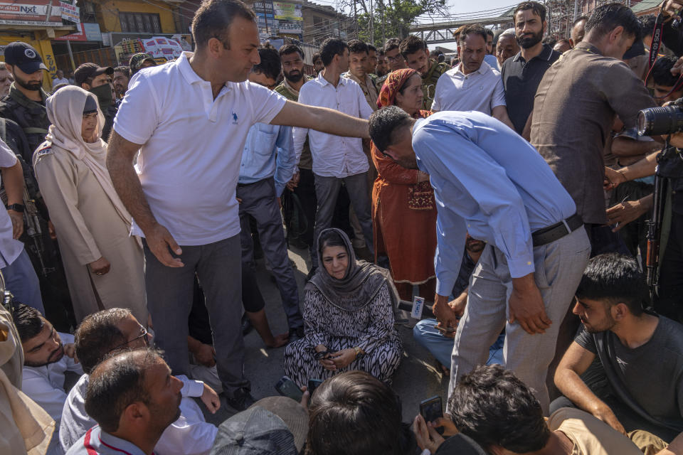 Jammu and Kashmir Peoples Democratic Party(PDP) President Mehbooba Mufti, center, blocks a road with her supporters as she protests against the alleged detention of her party workers ahead of the sixth round of polling in India's national election in Bijehara, south of Srinagar, Indian controlled Kashmir, Saturday, May 25, 2024. (AP Photo/Dar Yasin)