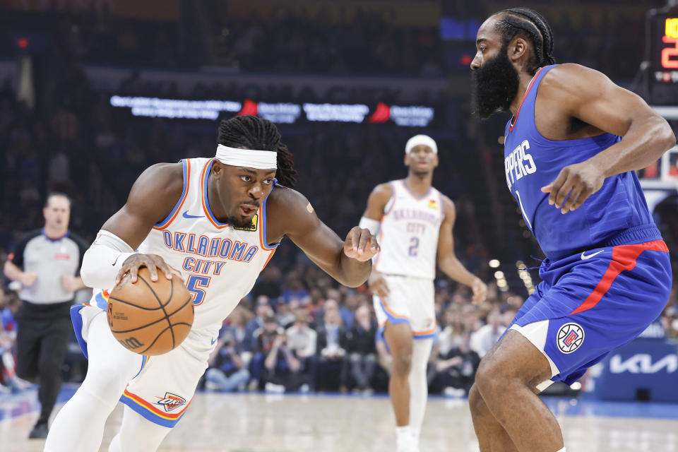 Feb 22, 2024; Oklahoma City, Oklahoma, USA; Oklahoma City Thunder guard Luguentz Dort (5) drives against LA Clippers guard James Harden (1) during the first quarter at Paycom Center. Mandatory Credit: Alonzo Adams-USA TODAY Sports