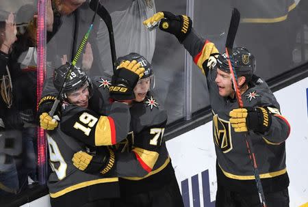 Feb 28, 2019; Las Vegas, NV, USA; Vegas Golden Knights right wing Reilly Smith (19) celebrates with center William Karlsson (71) and center Paul Stastny (26) after scoring a goal against the Florida Panthers during the third period at T-Mobile Arena. Mandatory Credit: Stephen R. Sylvanie-USA TODAY Sports