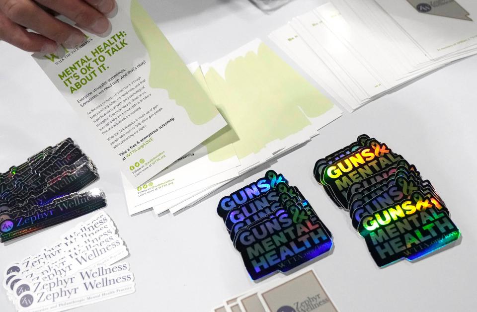 Stickers, pamphlets and information are available at the booth for Walk the Talk America, a group created to discuss mental health concerns among gun owners. The group appeared at the Concealed Carry & Home Defense Expo in Milwaukee in September 2023.