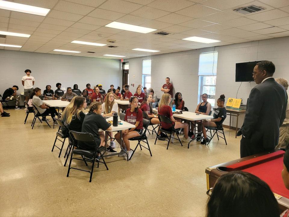Superintendent Tony Reddick talks with athletes from Gadsden City High School who turned out on Monday to assist with clean-up on Lookout Mountain. The area was hit last week by severe storms that downed trees and damaged homes.