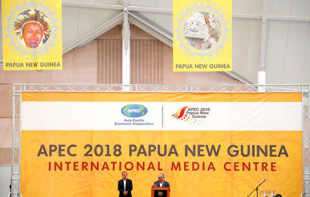 Papua New Guinea Prime Minister Peter O'Neill speaks as the Asia Pacific Economic Cooperation (APEC) Chief Executive Officer, Chris Hawkins listens during a media conference at the end of the APEC forum in Port Moresby, Papua New Guinea, November 18, 2018. REUTERS/David Gray