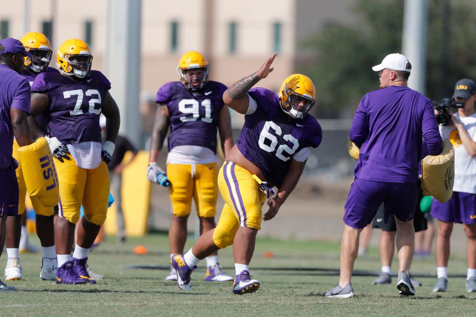 Former LSU nose tackle Siaki Ika (62) works out during a practice on Aug. 7, 2019.