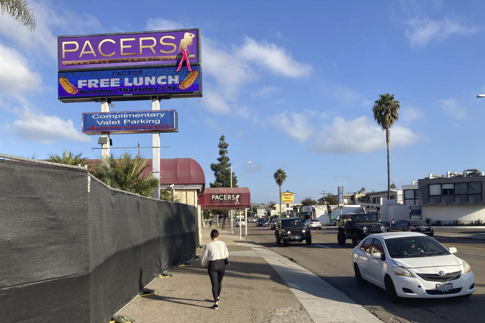 FILE - In this Dec. 10, 2020, file photo, a pedestrian walks past Pacers Showgirls International in San Diego. A California judge has extended an order exempting San Diego strip clubs from state pandemic-related restrictions, a setback for Gov. Gavin Newsom in his efforts to make his orders stick. (AP Photo/Elliot Spagat,File)