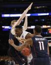 Iowa State's Melvin Ejim tries to move past Connecticut's Niels Giffey, left, and Ryan Boatright, right, during the first half in a regional semifinal of the NCAA men's college basketball tournament Friday, March 28, 2014, in New York. (AP Photo/Frank Franklin II)