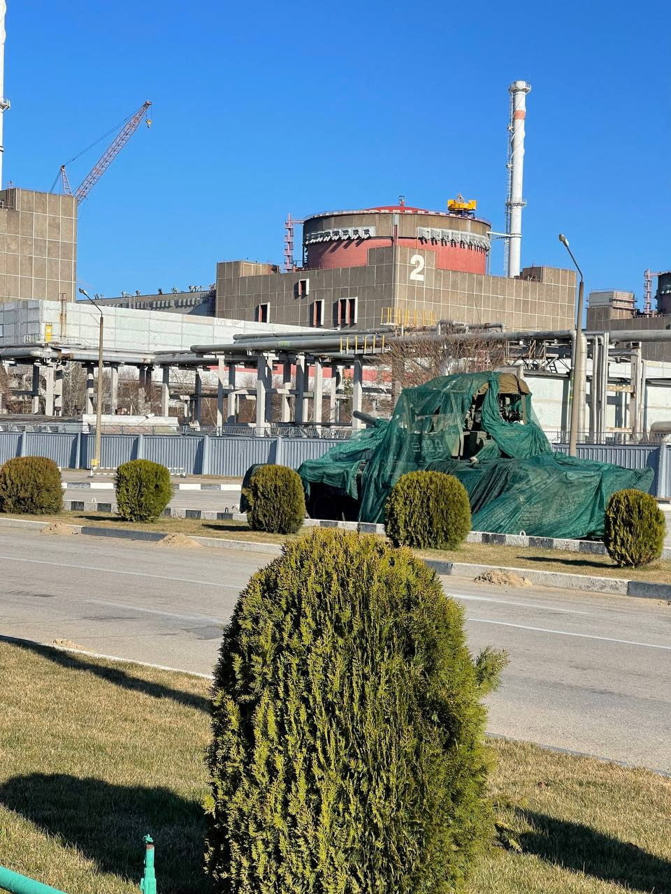 A view shows a Russian tank covered in green sheets outside Zaporizhzhia Nuclear Power Plant, amid Russia's invasion of Ukraine, in Enerhodar, Zaporizhzhia region, Ukraine, in this handout picture released March 16, 2022. Press service of National Nuclear Energy Generating Company Energoatom/Handout via REUTERS    ATTENTION EDITORS - THIS IMAGE HAS BEEN SUPPLIED BY A THIRD PARTY. MANDATORY CREDIT.