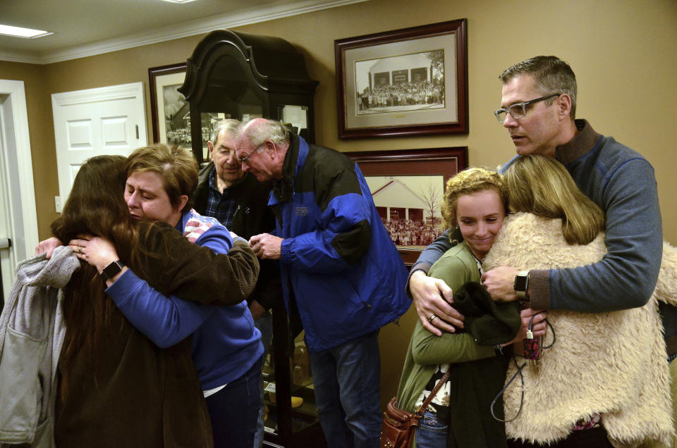 <p>Patrick Adamson, youth director and praise leader at Briensburg Baptist Church, comforts two people prior to a prayer vigil at Briensburg Baptist Church near Benton, Ky., Jan. 23, 2018. Bailey Nicole Holt and Preston Ryan Cope, both 15, were killed and more than a dozen injured when a classmate opened fire Tuesday morning in the Marshall County High School atrium, a common area at the school where several hallways meet and students gather before classes. (Photo: Stephen Lance Dennee/AP) </p>