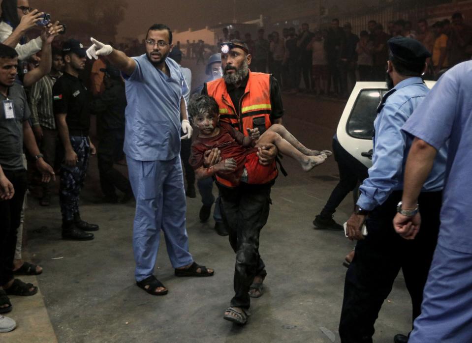 An injured child is rushed into a hospital in Khan Younis, in southern Gaza, following an Israeli air strike on Oct. 24, 2023.<span class="copyright">Yousef Masoud—The New York Times/Redux</span>