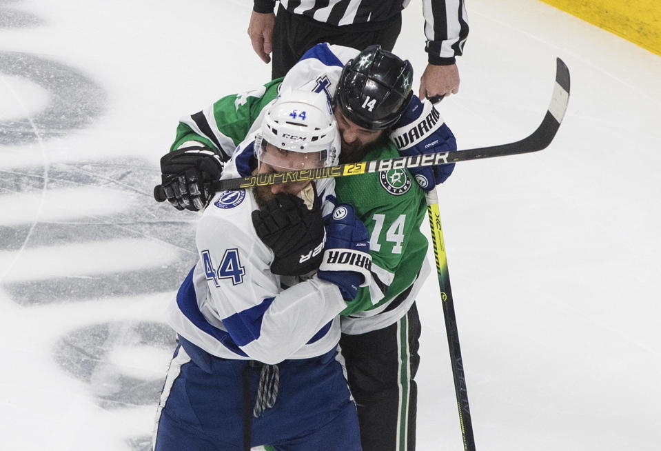 Dallas Stars left wing Jamie Benn (14) gets his glove over the face of Tampa Bay Lightning defenseman Jan Rutta (44) during the third period of Game 3 of the NHL hockey Stanley Cup Final, Wednesday, Sept. 23, 2020, in Edmonton, Alberta. (Jason Franson/The Canadian Press via AP)