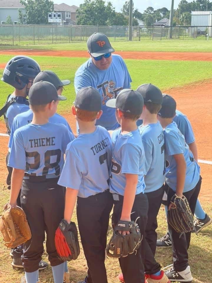 Children play baseball at the Tiger Point Sports Association.