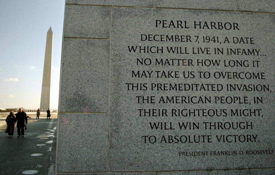 Visitors walk near former U.S. President Franklin Roosevelt's Pearl Harbor speech, chiselled on the World War II Memorial on the National Mall, in Washington, December 7, 2005. [The December 7, 1941, Japanese aerial attack on the U.S. fleet in Hawaii, killed 2,390 and damaged 21 ships, bringing the United States fully into] World War II.