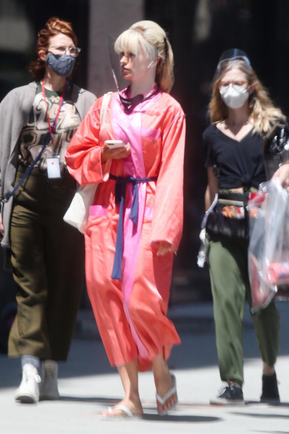 <p>Lily James gets into character as Pamela Anderson on the set of Hulu's <em>Pam & Tommy</em> on Monday in L.A.</p>