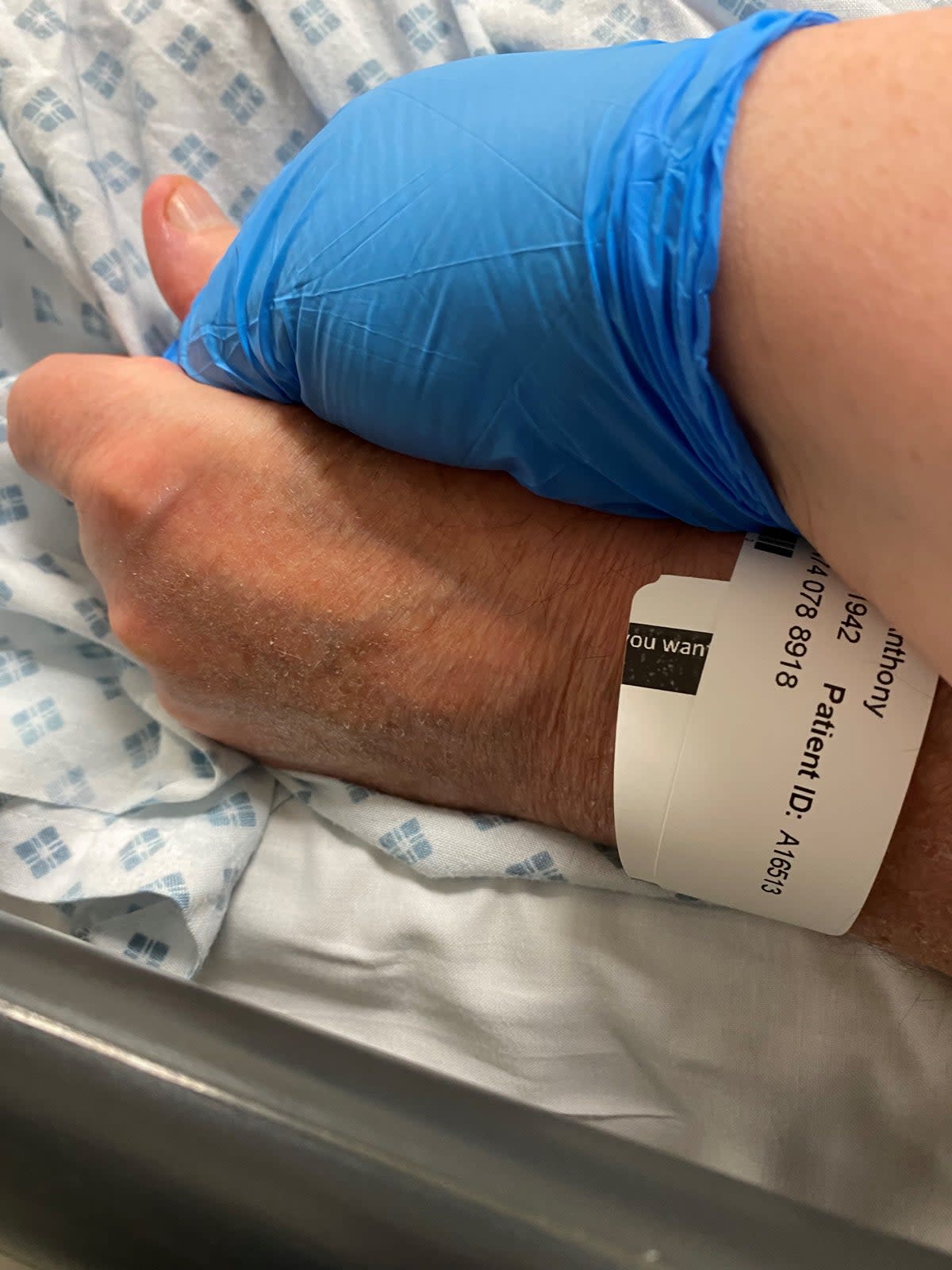 Ms Carney holds her father’s hand in hospital the last time she ever saw him (Ruth Carney)