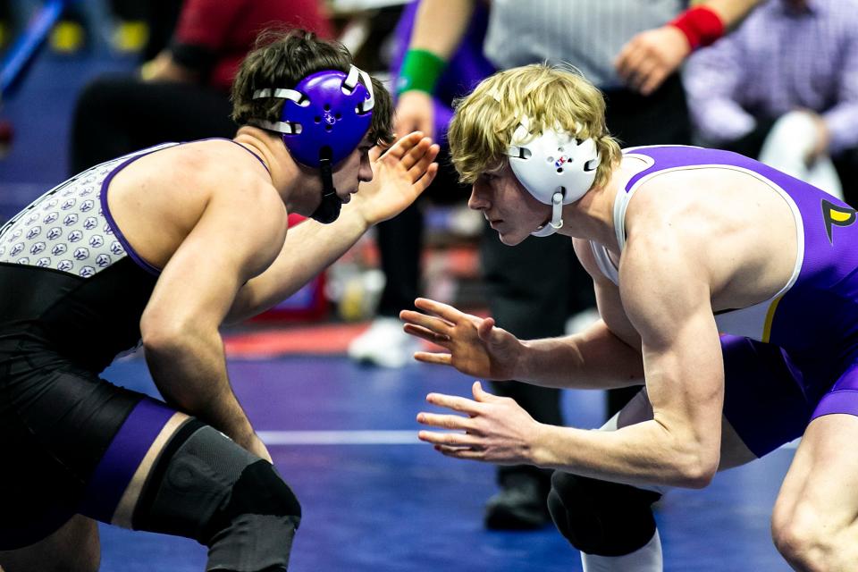 Norwalk's Dominic Tigner, left, wrestles Johnston's Jacob Helgeson at 152 pounds during the Class 3A high school boys state wrestling tournament quarterfinals, Thursday, Feb. 16, 2023, at Wells Fargo Arena in Des Moines, Iowa.