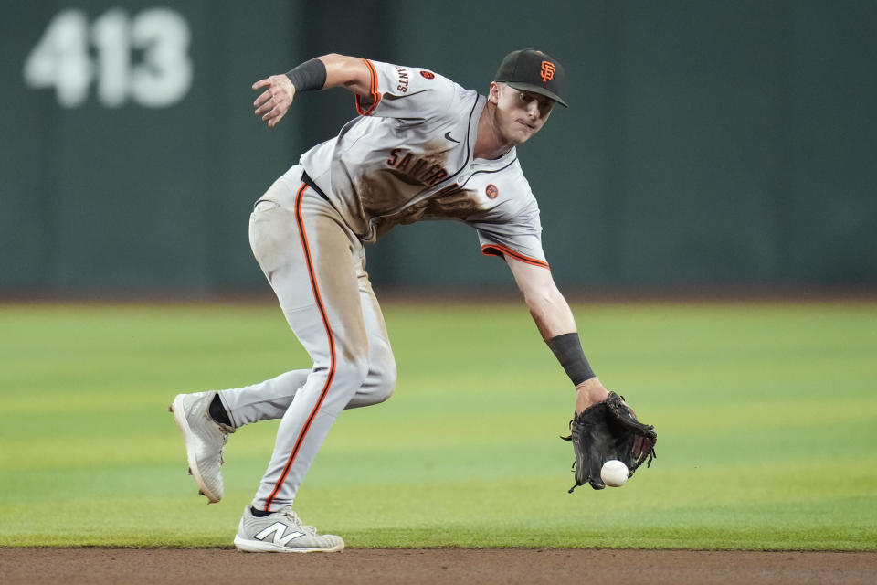 San Francisco Giants shortstop Tyler Fitzgerald makes a glove stop on an infield single by Arizona Diamondbacks' Josh Bell during the ninth inning of a baseball game Tuesday, Sept. 24, 2024, in Phoenix. (AP Photo/Ross D. Franklin)