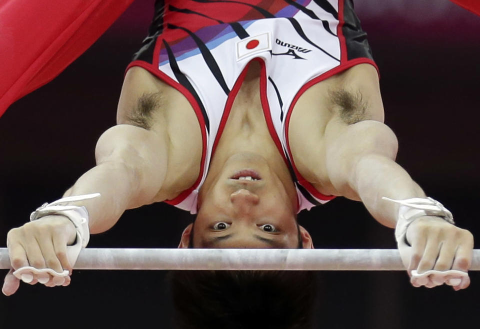 Japanese gymnast Kazuhito Tanaka performs on the horizontal bar during the artistic gymnastics men's individual all-around competition at the 2012 Summer Olympics, Wednesday, Aug. 1, 2012, in London. (AP Photo/Gregory Bull)