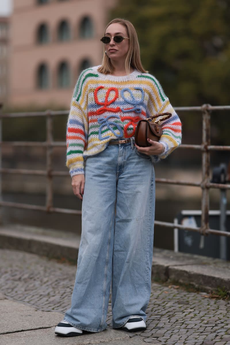 <p> Knitwear and denim combinations form the basis of many great autumn winter outfits. For a striking day look, pair a bright knit with classic blue wide leg jeans and trainers. It’ll look like you put way more effort into your outfit than you actually did. Don't forget to half tuck to show off your waist. </p>