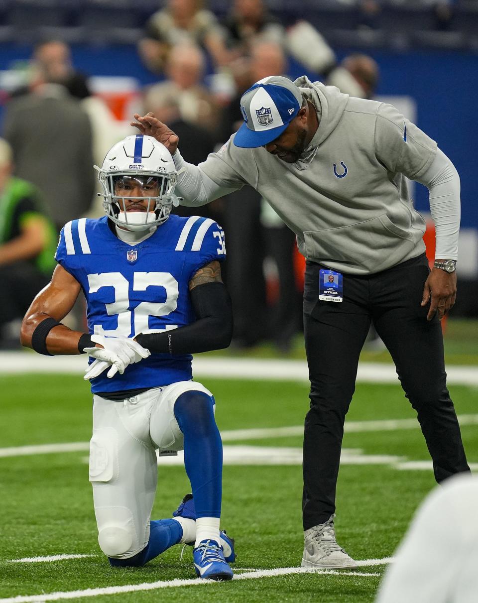 Indianapolis Colts safety Julian Blackmon (32) gets a pat on the head from coach Mike Mitchell on Sunday, Oct. 29, 2023, before facing the New Orleans Saints at Lucas Oil Stadium in Indianapolis.