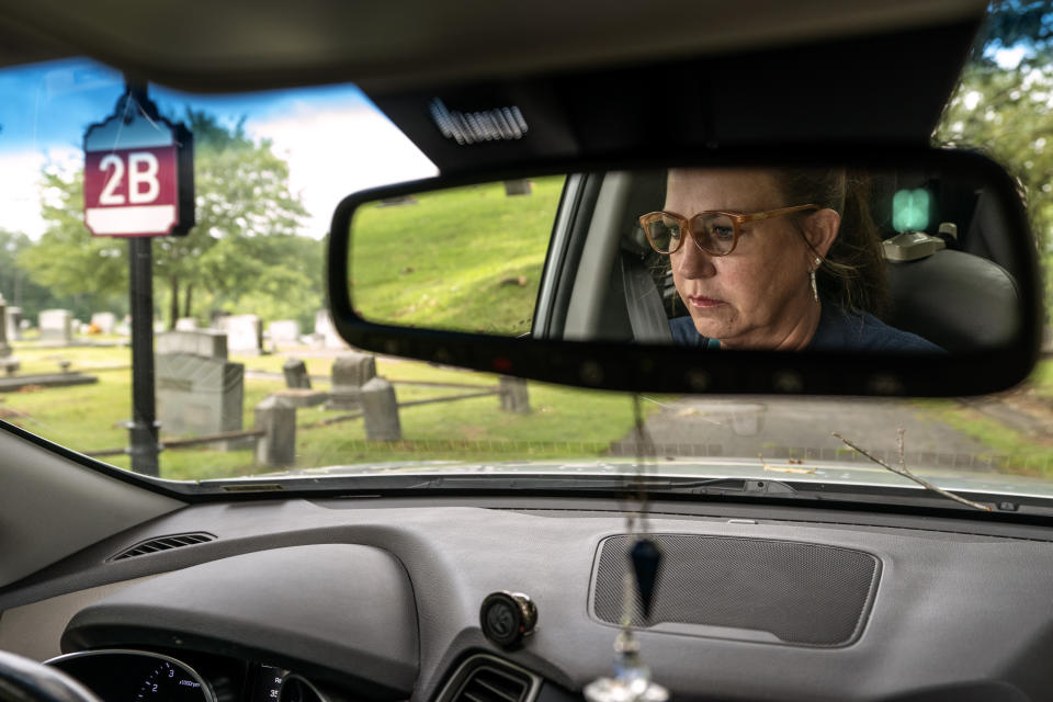 Janet Paulsen drives through the cemetery in Acworth, Ga., Tuesday, Aug. 8, 2023, where she said her estranged husband used to park with their twins and drink before coming home. “Isn’t that sick?” she asked out loud. (AP Photo/David Goldman)