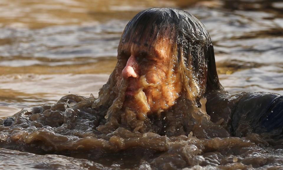 A competitor shakes water off his head during the Tough Guy event in Perton, central England