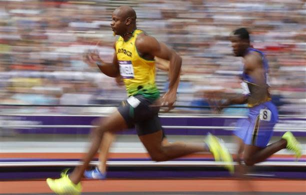 Asafa Powell of Jamaica runs on his way to winning his 100m heat round 1 during the London 2012 Olympic Games at the Olympic Stadium August 4, 2012.