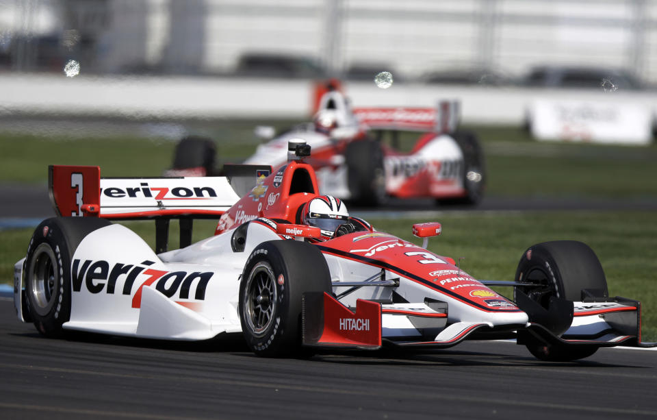 Helio Castroneves, of Brazil, leads teammate Juan Pablo Montoya, of Colombia, through turn 7 during practice for the inaugural Grand Prix of Indianapolis IndyCar auto race at the Indianapolis Motor Speedway in Indianapolis, Thursday, May 8, 2014. (AP Photo/Michael Conroy)